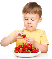 Image showing Little boy with strawberries