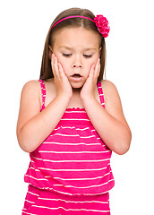 Image showing Little girl is holding her face in astonishment