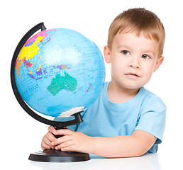 Image showing Happy little boy with a globe