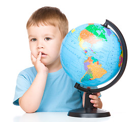 Image showing Little boy with a globe