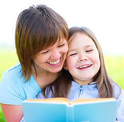 Image showing Mother is reading book with her daughter