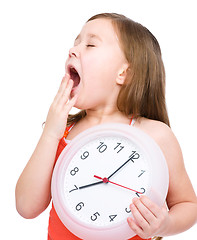 Image showing Little girl is holding big clock