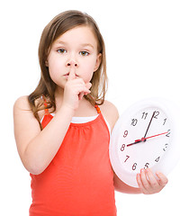 Image showing Little girl is holding big clock