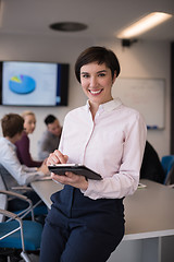 Image showing hispanic businesswoman with tablet at meeting room