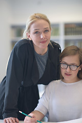 Image showing female teacher helping students on class