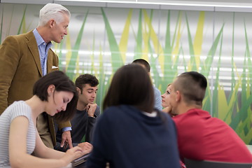 Image showing teacher with a group of students in classroom