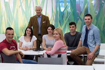 Image showing portrait of  teacher with students group in background