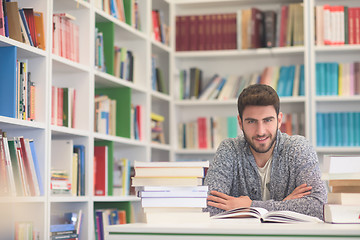 Image showing portrait of student while reading book  in school library