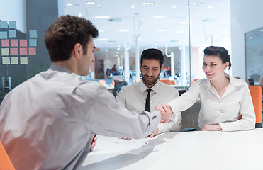 Image showing young couple signing contract documents on partners back