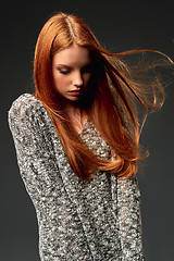 Image showing Fashion portrait of beautiful red haired girl with flying hair