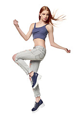 Image showing Hip-hop style teenage girl jumping dancing