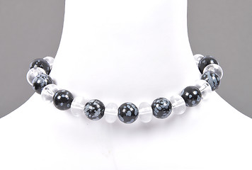 Image showing Rock crystal and snowflake obsidian chain on bust