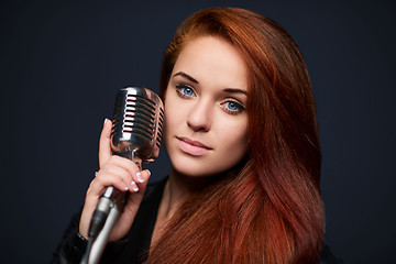 Image showing Closeup of young woman with retro microphone