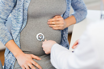 Image showing doctor with stethoscope and pregnant woman belly