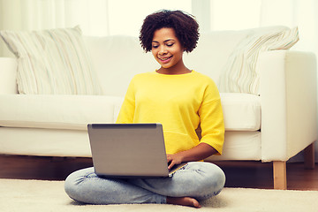 Image showing happy african american woman with laptop at home