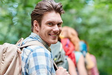 Image showing group of smiling friends with backpacks hiking