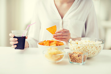 Image showing close up of woman with junk food and coca cola cup
