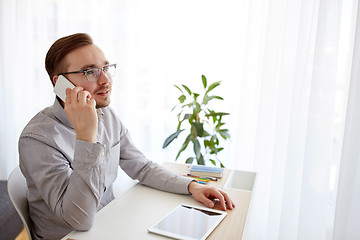 Image showing happy creative male worker calling on smarphone