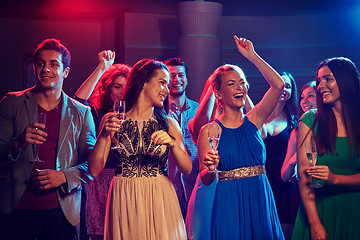 Image showing happy friends with glasses of champagne in club