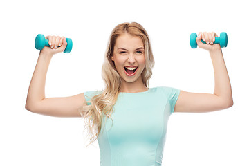 Image showing smiling beautiful young sporty woman with dumbbell