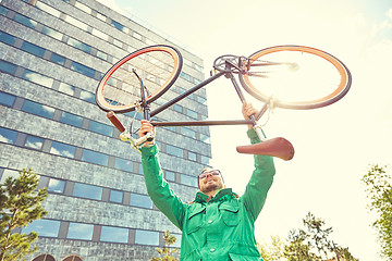 Image showing young hipster man rising fixed gear bike in city