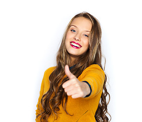 Image showing happy young woman or teen girl showing thumbs up