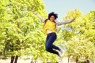 Image showing happy african american young woman in summer park