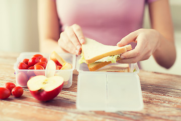 Image showing close up of woman with food in plastic container