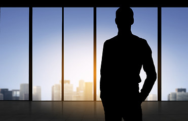 Image showing silhouette of business man over office background