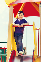 Image showing happy little boy climbing on children playground