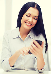 Image showing businesswoman or student with smartphone