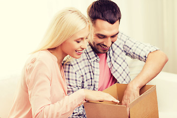 Image showing happy couple with parcel box at home