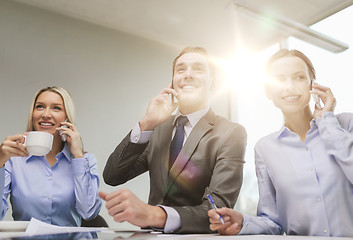 Image showing business team with smartphones having conversation