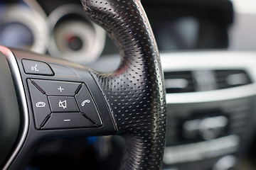 Image showing Steering wheel of  car, details of phone adjustment controls