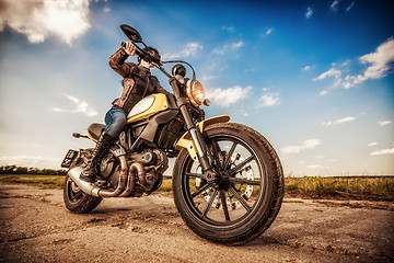 Image showing Biker girl on a motorcycle