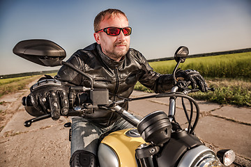 Image showing Biker racing on the road