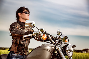 Image showing Biker girl sitting on motorcycle