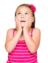 Image showing Little girl is holding her face in astonishment