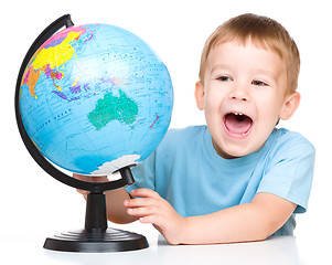 Image showing Happy little boy with a globe