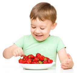 Image showing Happy little boy with strawberries