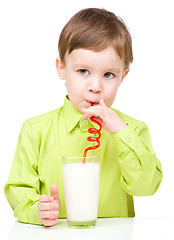 Image showing Cute little boy with a glass of milk