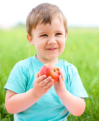 Image showing Portrait of a happy little boy with apple