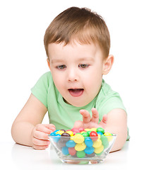 Image showing Portrait of a boy with candies