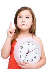 Image showing Little girl is holding big clock