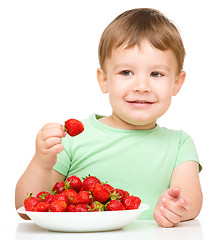 Image showing Happy little boy with strawberries