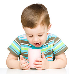 Image showing Cute little boy with a glass of milk