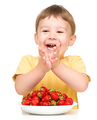 Image showing Little boy with strawberries