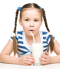 Image showing Cute little girl with a glass of milk