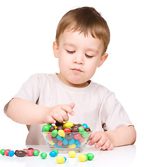 Image showing Portrait of a boy with candies