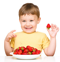 Image showing Happy little boy with strawberries